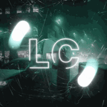 a neon sign that says lc on a dark background