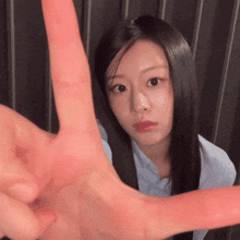 a woman making a stop sign with her hands