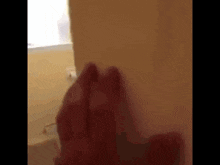 a close up of a person 's hand on a wall in a bathroom