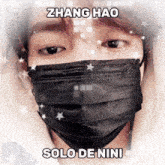 zhang hao solo de nini is written on a picture of a person wearing a black face mask