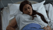 a woman is laying in a hospital bed with an oxygen mask on her face