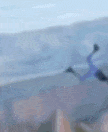 a blurry picture of a man with a beard and a blue helmet