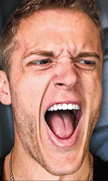 a close up of a man with his mouth open