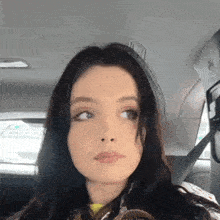 a close up of a woman sitting in the back seat of a car .