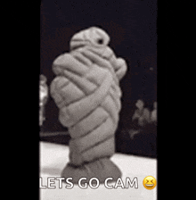 a black and white photo of a statue that says lets go cam on it