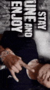 a man laying down with the words " stay one and enjoy " above him