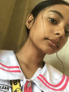 a girl taking a selfie with a yellow strap that says " i3a9 "