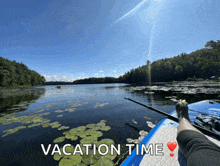 a person fishing on a lake with the words vacation time written below them