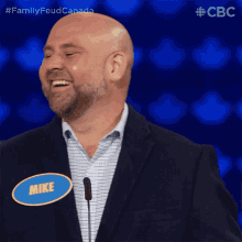 a man in a suit has a name tag that says mike on it
