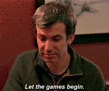 a man says let the games begin while sitting at a table