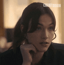 a close up of a woman 's face with the word countdown on the bottom right