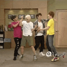 a group of young men are dancing in a room and one of them is wearing a yellow shirt that says ?