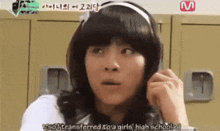 a girl in a wig is talking on a cell phone in front of a sign that says ' m ' on it