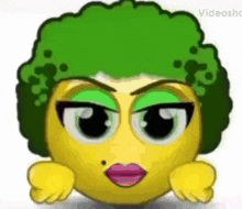 a cartoon smiley face with green hair and red lips
