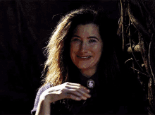 a woman with long hair and purple eyes is wearing a purple sweater
