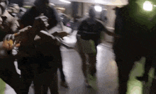 a blurry picture of a group of people standing in a hallway .