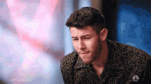 a man in a leopard print shirt is on nbc 's show the voice