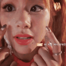 a close up of a woman 's face with korean writing