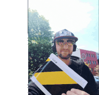 a man wearing headphones stands in front of a building that says muzeum polskiej piosenki