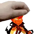 a hand is holding a cartoon character with a hat on .