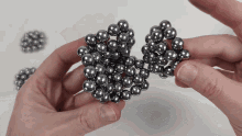 a person is holding a bunch of balls in their hands