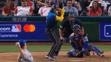 a baseball game is being played with a phillies.com ad in the background