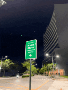 a green sign that says maple grove is on a pole