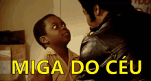 a man in a leather jacket talks to a young boy with the words miga do ceu written in yellow