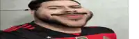 a man with a beard wearing a red and black shirt with the letter r on it