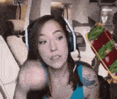a woman wearing headphones is pointing at something in front of a sign that says break