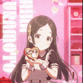 a girl in a maid outfit is holding a heart shaped cookie in her hands