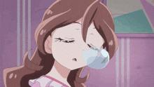a close up of a girl blowing a bubble with her eyes closed