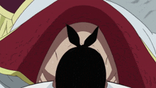 a close up of a person 's face with a red hood