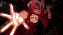 a person in a red hoodie is reaching out towards something with their hands .