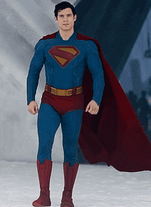 a man in a blue and red superman costume