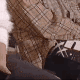 a man in a plaid shirt is sitting on a chair with a woman .