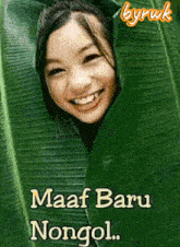 a picture of a girl behind a green leaf with the words maaf baru nongol