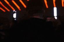 a man and a woman are kissing in front of a crowd of people