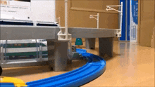 a toy train is going down a blue track