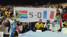a group of people holding a banner that says 5-0 on it
