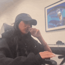 a woman wearing a blue hat that says ' boston bruins ' on it