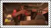 a man in a red uniform is holding a gun and a mug .