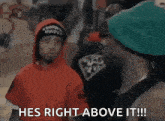 a group of men are standing next to each other and one of them says he 's right above it .