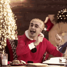 a man dressed as santa claus is holding a sparkler