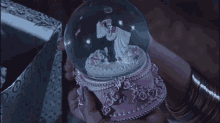a snow globe with a bride and groom inside of it