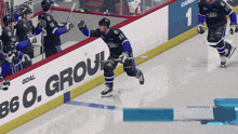 a hockey game is being played in front of a sign that says so grou