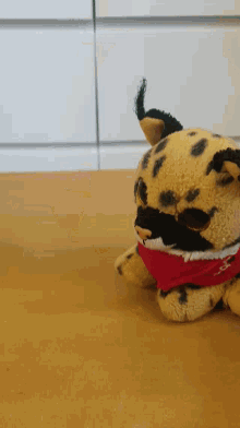 a stuffed animal with a red scarf around its neck that says i love you