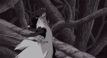 a man in a white robe is holding a sword in his hand .