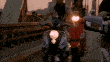 a group of people are riding scooters on a bridge at sunset
