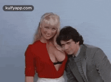 two men and a woman are posing for a picture together .